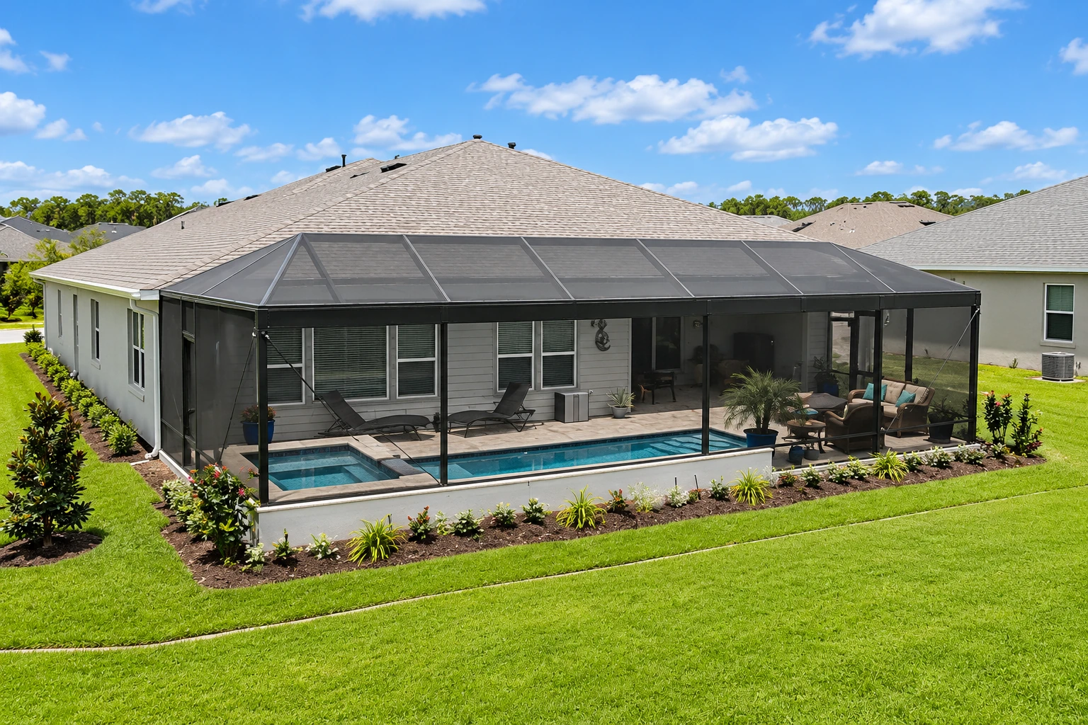 Single-story home with a large screened patio enclosure around a swimming pool and seating area.